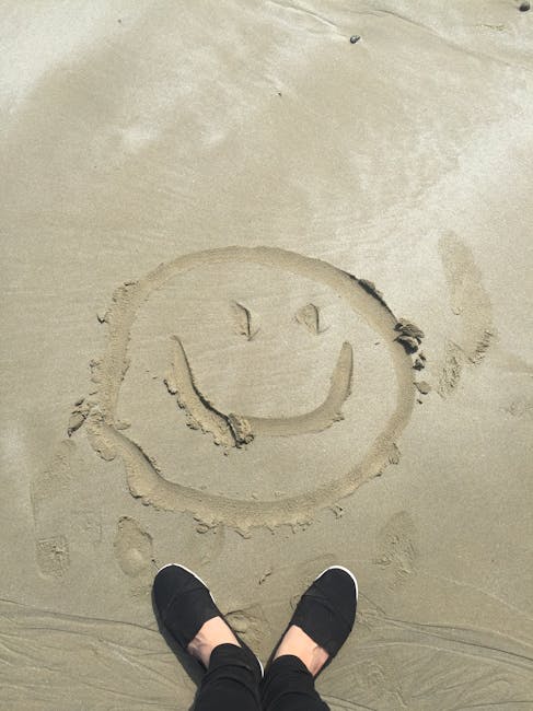 a smiley face drawn in the sand showing that imbue cleaning solutions provides happy faces after our cleaning services