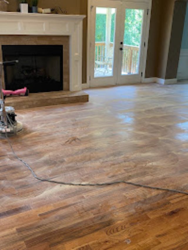 Imbue Cleaning Solutions worker performing light sanding on wood floors known as screening getting floors ready to to be recoated with polyurethane this is part of our wood floor cleaning program