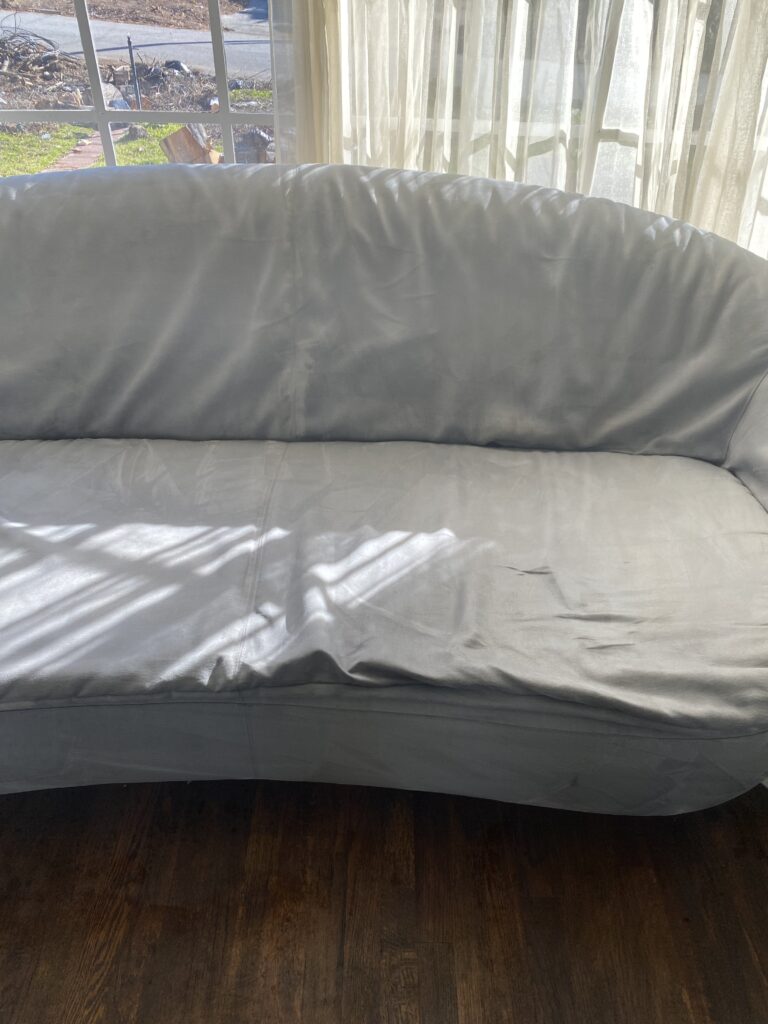 imbue cleaning solutions worker providing sofa cleaning and is now showing the final result of a clean sofa which is apart of our upholstery cleaning services program